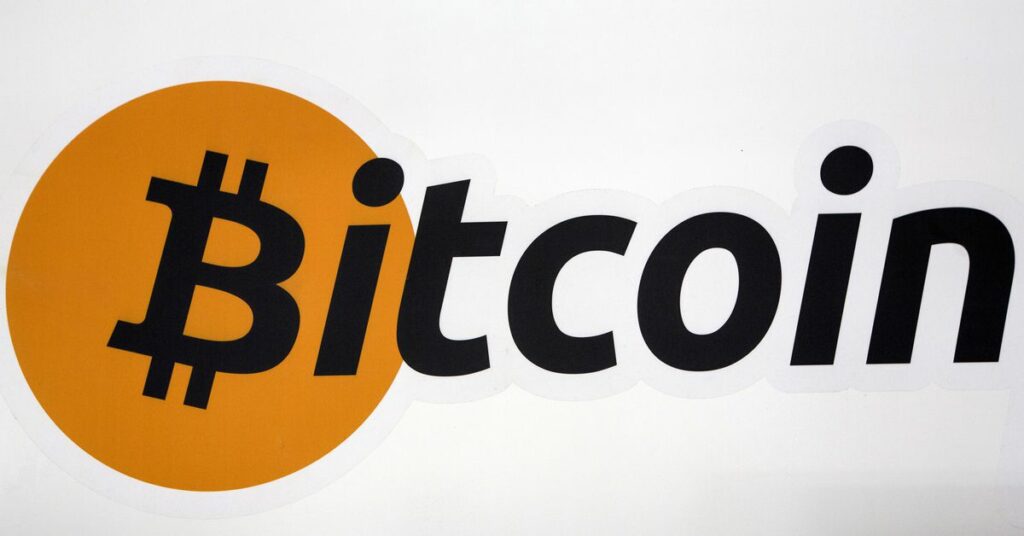 A Bitcoin logo is displayed at the Bitcoin Center New York City in New York