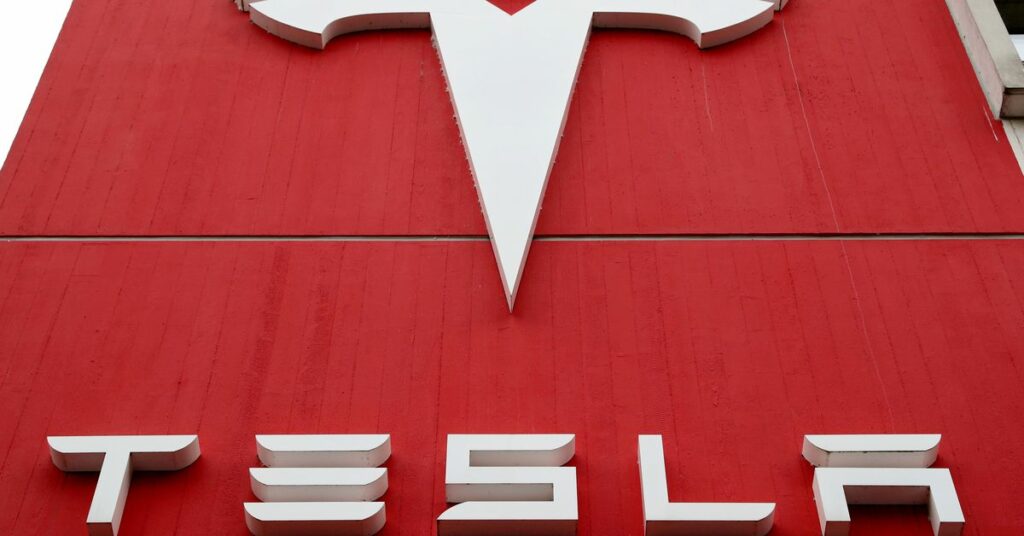 The logo of car manufacturer Tesla is seen at a branch office in Bern, Switzerland October 28, 2020. REUTERS/Arnd Wiegmann