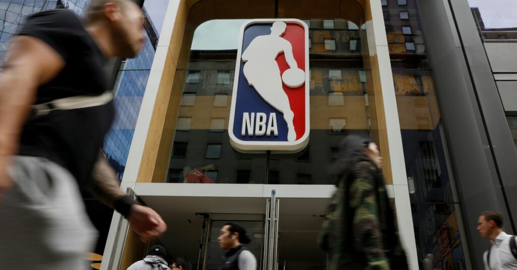 The NBA logo is displayed as people pass by the NBA Store in New York City, U.S., October 7, 2019. REUTERS/Brendan McDermid