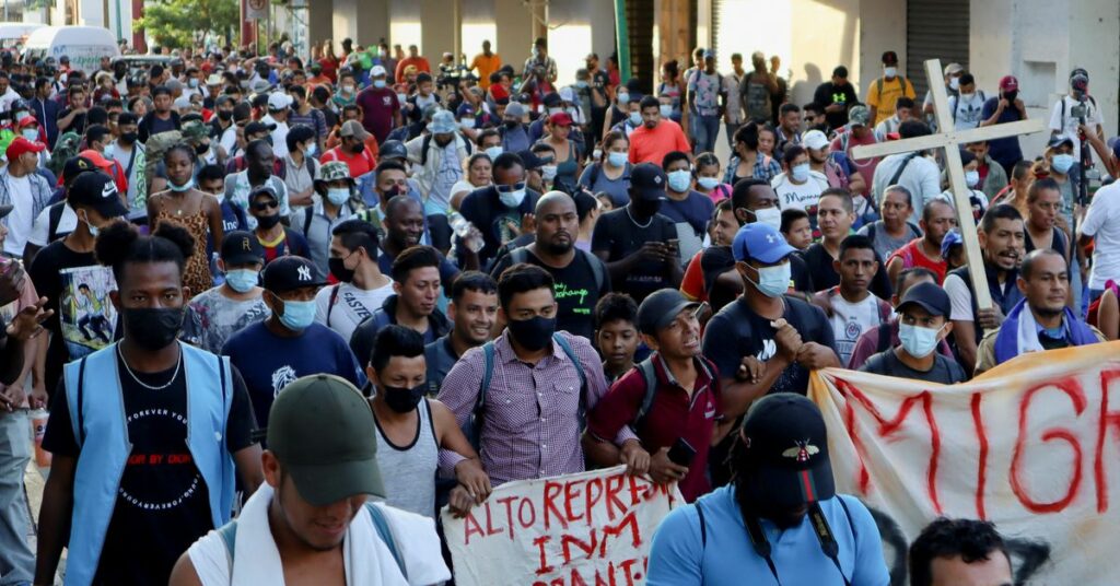 Migrants from Central America and Haiti clash with National Guard members as they walk in a caravan headed to the Mexican capital to apply for asylum and refugee status, in Tapachula, in Chiapas state, Mexico October 23, 2021. REUTERS/Jose Torres