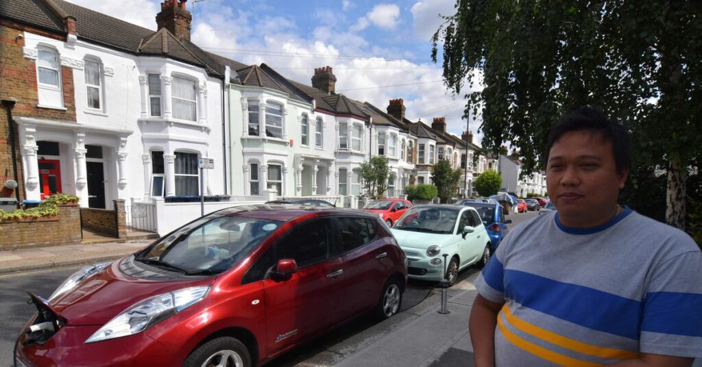 Richard Stobart, CEO of an electric vehicle charging system startup company Char.gy, demonstrates one of the company