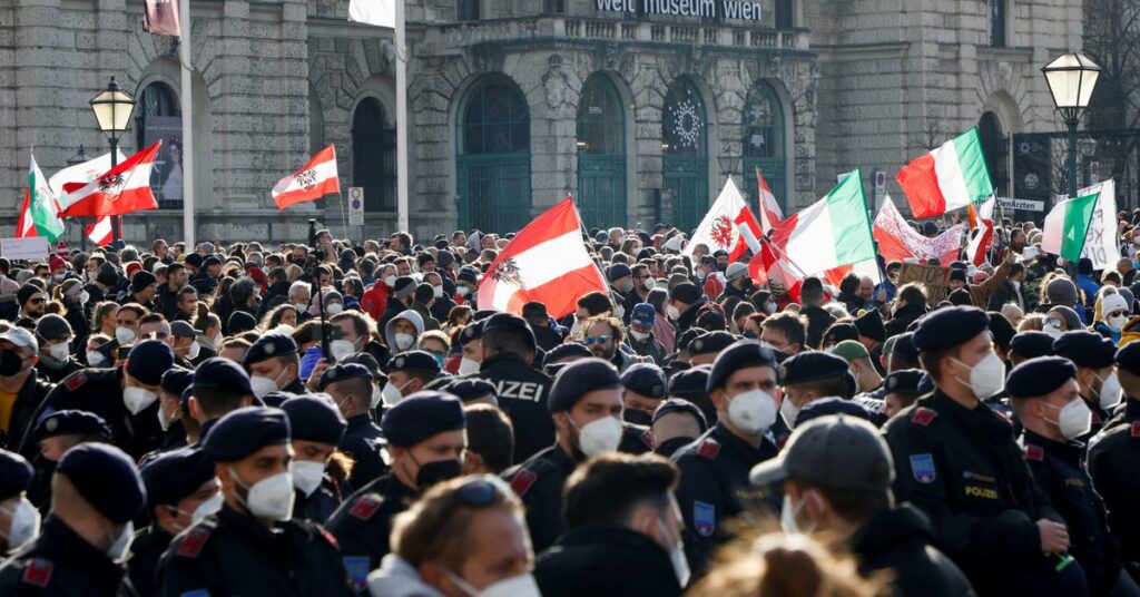 A demonstrator is detained by police officers during a protest against the coronavirus disease (COVID-19) measures in Vienna, Austria, November 20, 2021. REUTERS/Leonhard Foeger