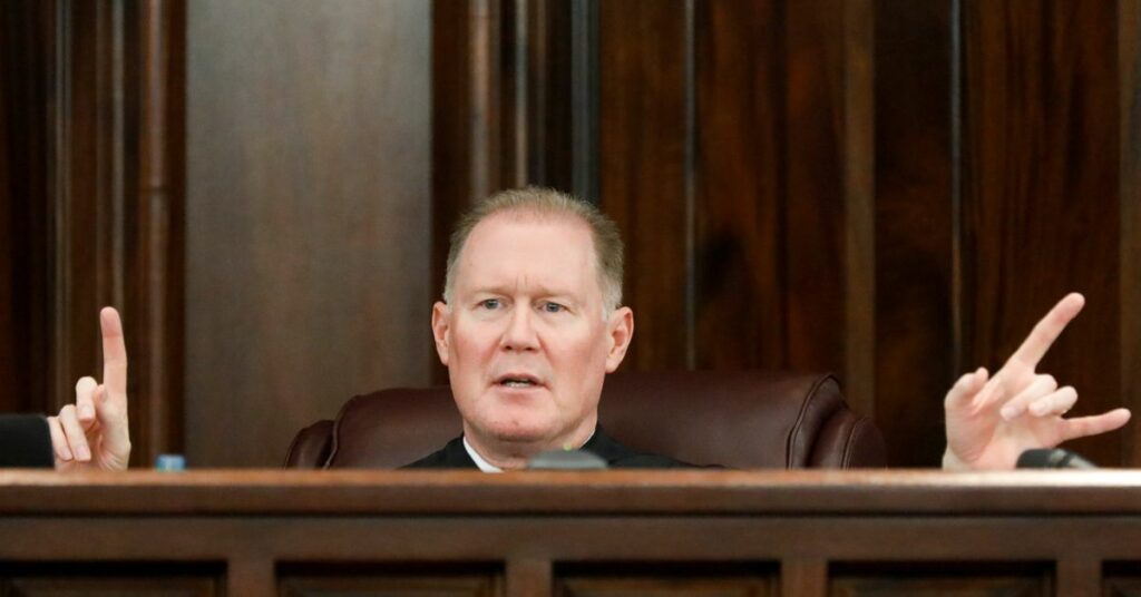 Defendant Travis McMichael looks on during his trial and of William