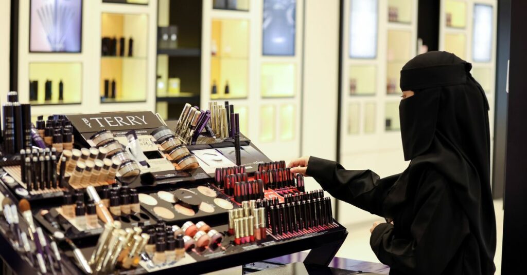 A Saudi woman arranges the perfumes in a cosmetic shop at Centria Mall in Riyadh, Saudi Arabia, October 22, 2021. REUTERS/Ahmed Yosri