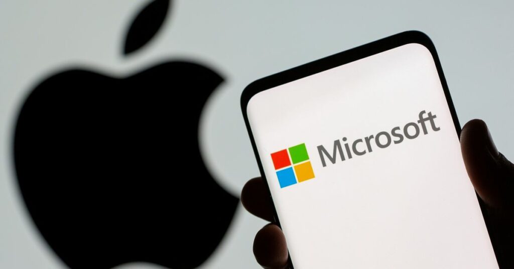 Microsoft logo is seen on the smartphone in front of displayed Apple logo in this illustration taken, July 26, 2021. REUTERS/Dado Ruvic/Illustration