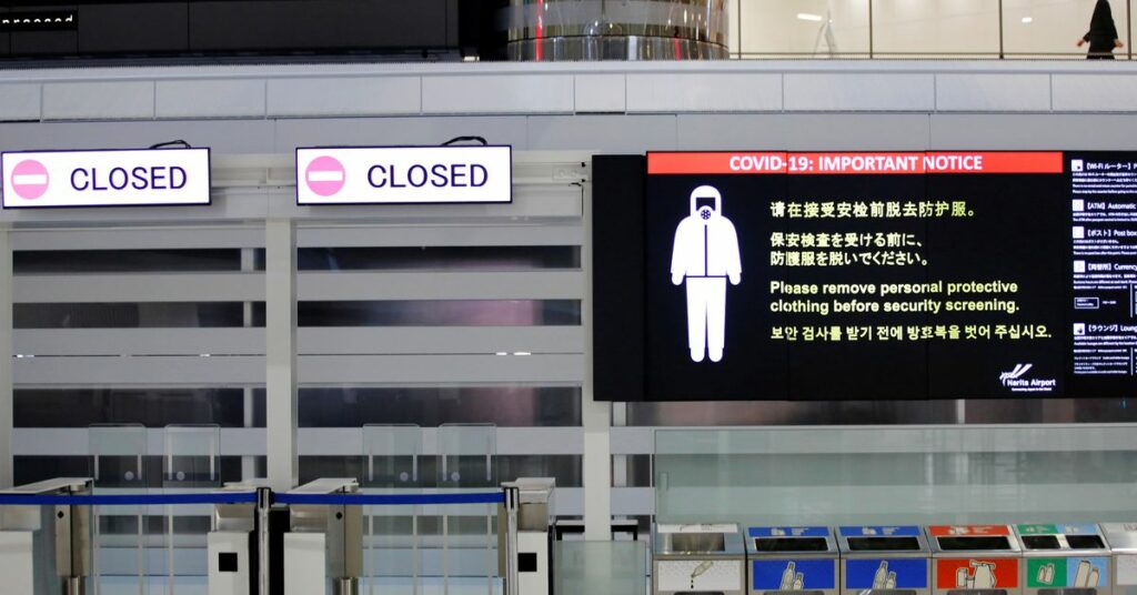 A notice about COVID-19 safety measures is pictured next to closed doors at a departure hall of Narita international airport on the first day of closed borders to prevent the spread of the new coronavirus Omicron variant in Narita, east of Tokyo, Japan, November 30, 2021. REUTERS/Kim Kyung-Hoon