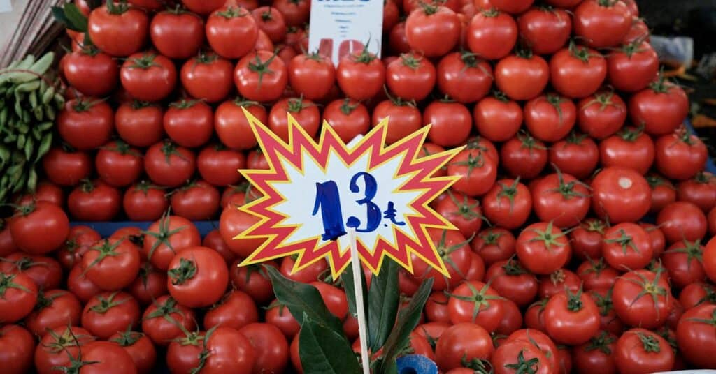 A vendor arranges signs displaying the prices of fruits in his stall at a street market, in Mexico City, Mexico December 17, 2021. REUTERS/Luis Cortes/File Photo