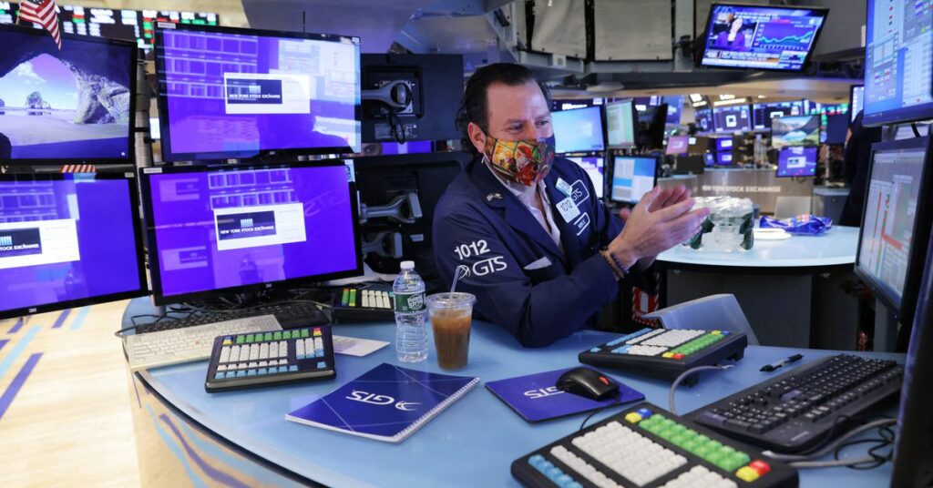 A trader works on the trading floor at the New York Stock Exchange (NYSE) in Manhattan, New York City, U.S., December 28, 2021. REUTERS/Andrew Kelly