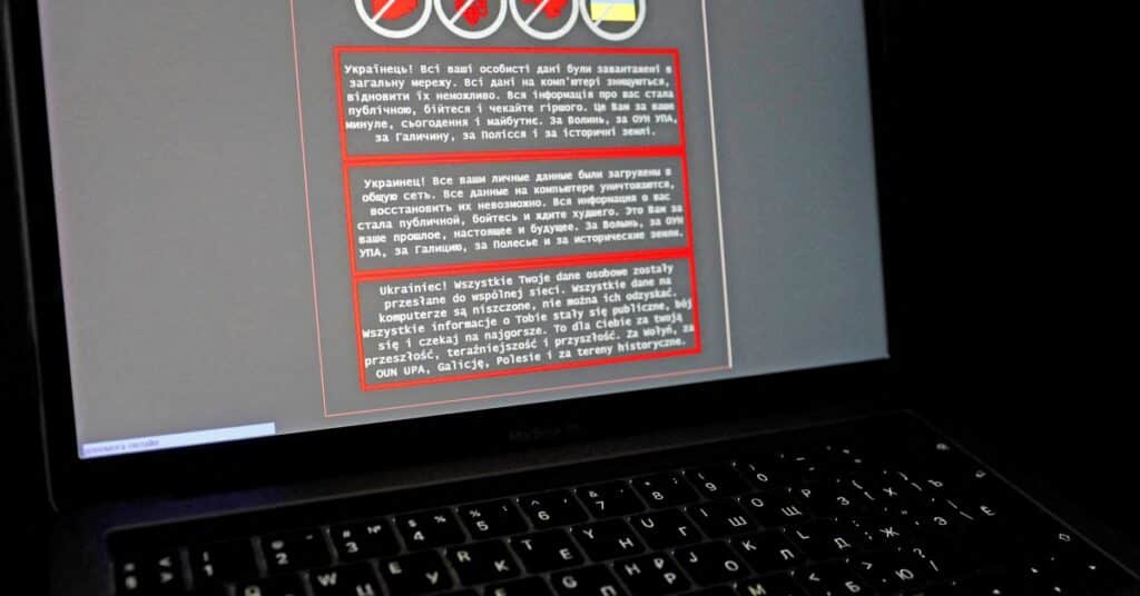 A laptop screen displays a warning message in Ukrainian, Russian and Polish, that appeared on the official website of the Ukrainian Foreign Ministry after a massive cyberattack, in this illustration taken January 14, 2022. REUTERS/Valentyn Ogirenko/Illustration