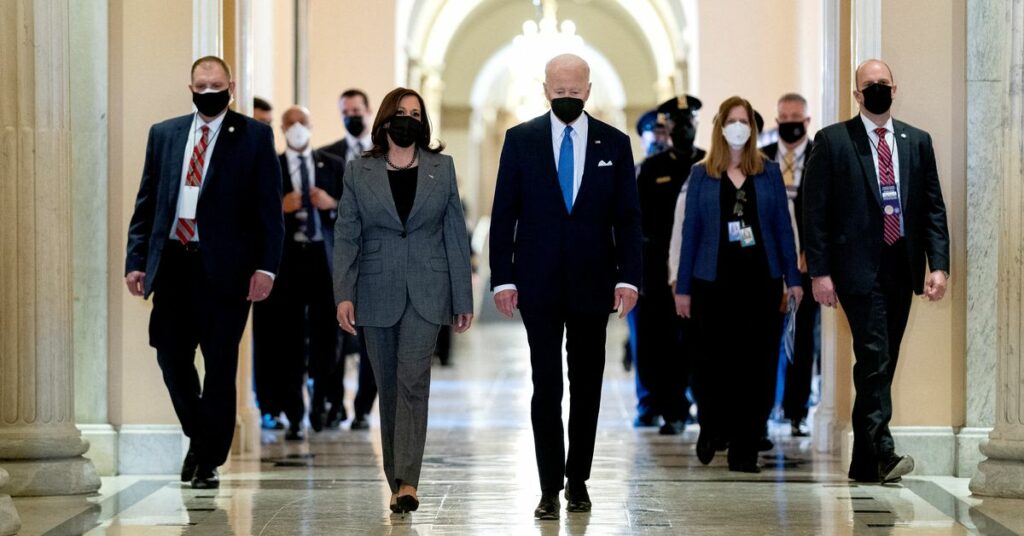 U.S. Vice President Kamala Harris and U.S. President Joe Biden walk through the Hall of Columns on the one-year anniversary of the January 6, 2021 attack on the Capitol in Washington, U.S., January 6, 2022. Stefani Reynolds/Pool via REUTERS