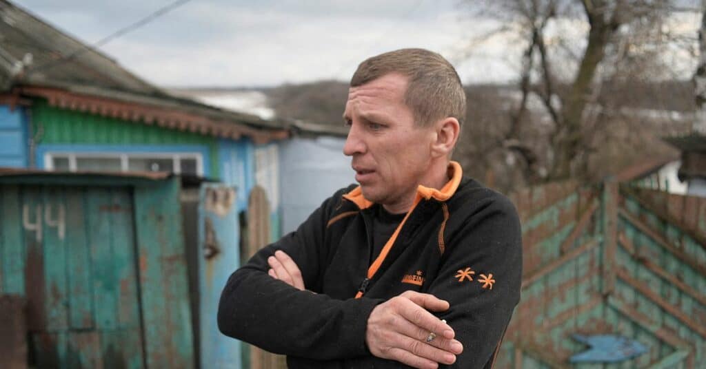 Local resident Serhiy smokes near his house in the village of Katerynivka, located near the line of separation from Russian-backed rebels, in Luhansk Region, Ukraine January 7, 2022.  REUTERS/Maksim Levin