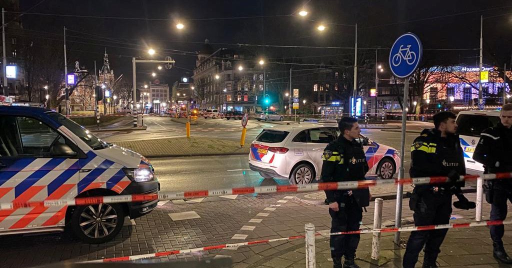 A police officer stands near an Apple store in central Amsterdam during a hostage incident in the store, in Amsterdam, Netherlands February 22, 2022. REUTERS/Piroschka van de Wouw