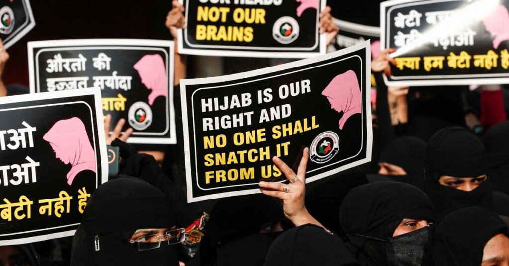 A woman holds a placard during a protest, organised by Hum Bhartiya, against the recent hijab ban in few colleges of Karnataka state, on the outskirts of Mumbai, India, February 11, 2022. REUTERS/Francis Mascarenhas