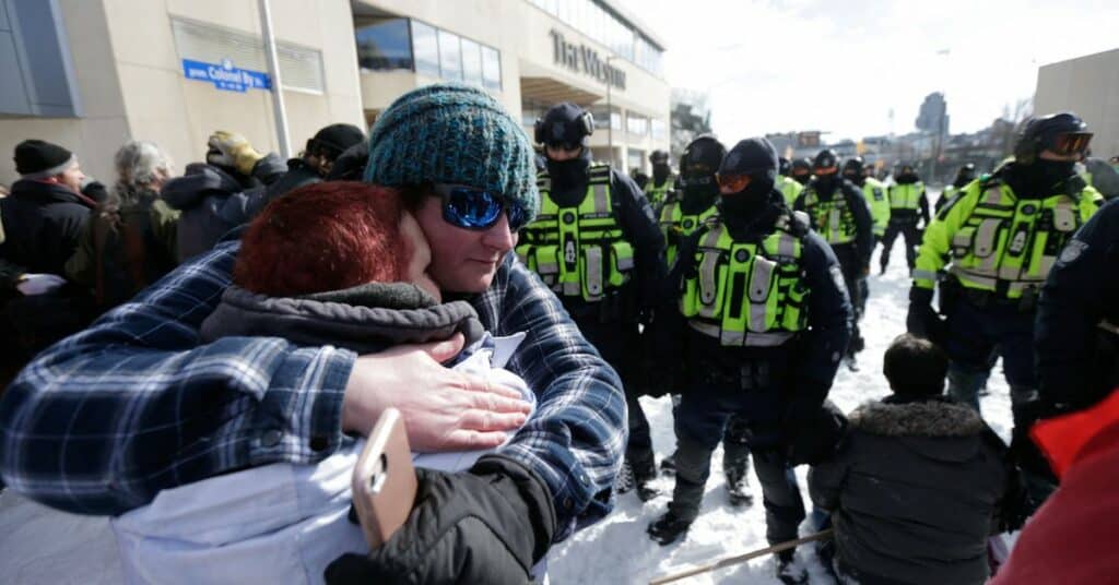 Police officers stand guard as truckers and supporters continue to protest coronavirus disease (COVID-19) vaccine mandates, on Wellington Street in Ottawa, Ontario, Canada, February 18, 2022.  REUTERS/Shannon Stapleton