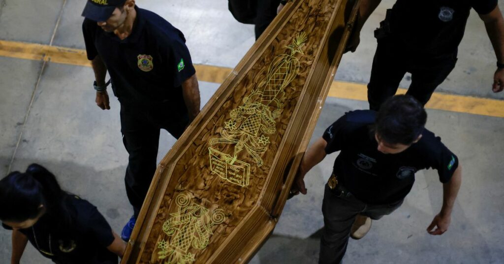 Federal Police officers carry a coffin containing human remains after a suspect confessed to killing British journalist Dom Phillips and Brazilian indigenous expert Bruno Pereira, in Brasilia