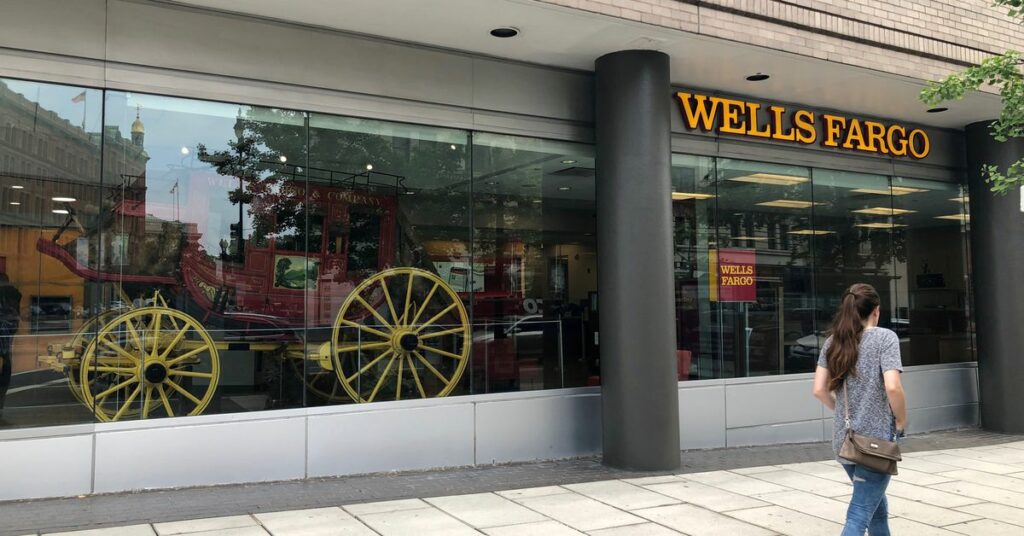 A lady walks by a Wells Fargo bank branch in Washington