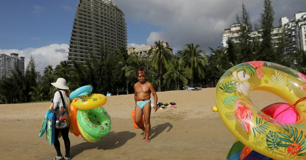 People shop at the Sanya International Duty-Free Shopping Complex in Sanya