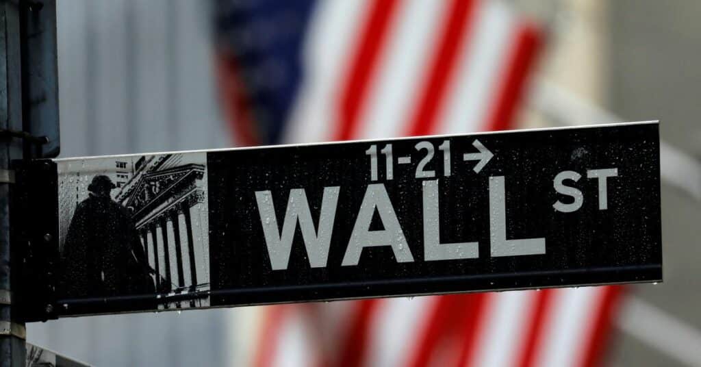 Raindrops hang on a sign for Wall Street outside the New York Stock Exchange in New York