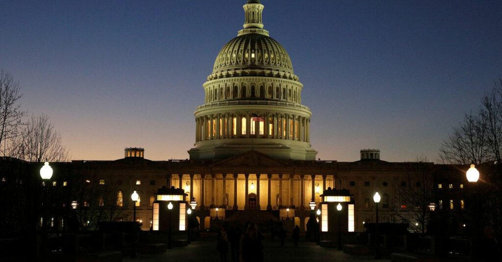 The U.S. Capitol Building is lit at sunset in Washington