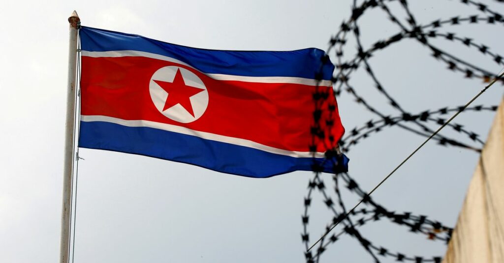 A North Korea flag flutters next to concertina wire at the North Korean embassy in Kuala Lumpur