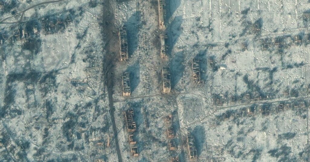 A satellite view shows destroyed apartment buildings and homes, in Soledar