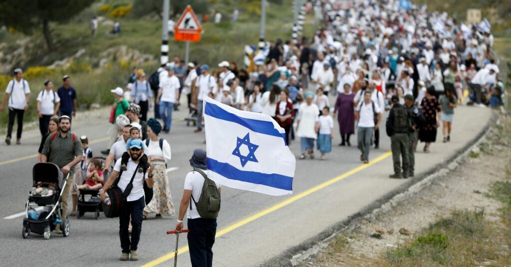 Israeli settlers hold a protest march in West Bank