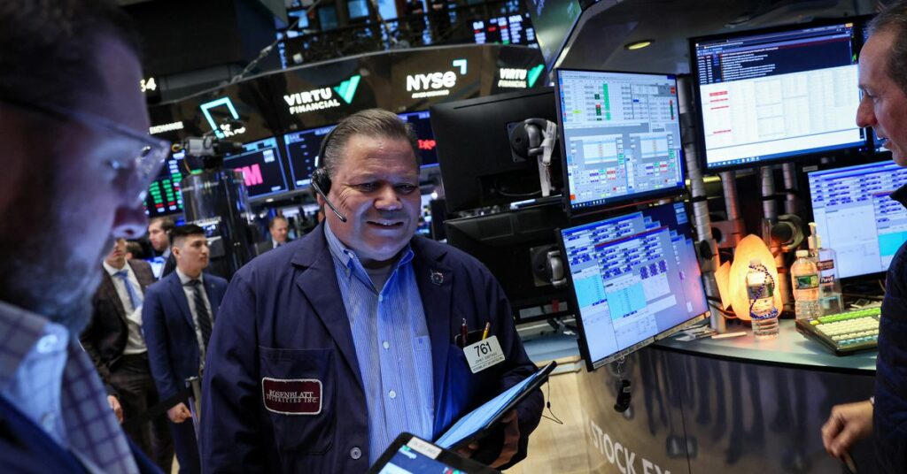 Traders work on the floor of the NYSE in New York