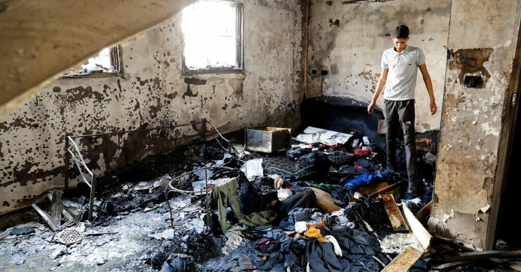 A man stands in a damaged building at the site of deadly Israeli raid in Balata camp