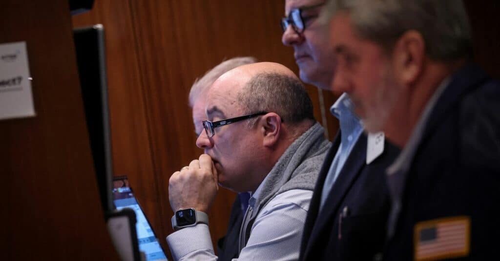 Traders work on the floor of the NYSE in New York