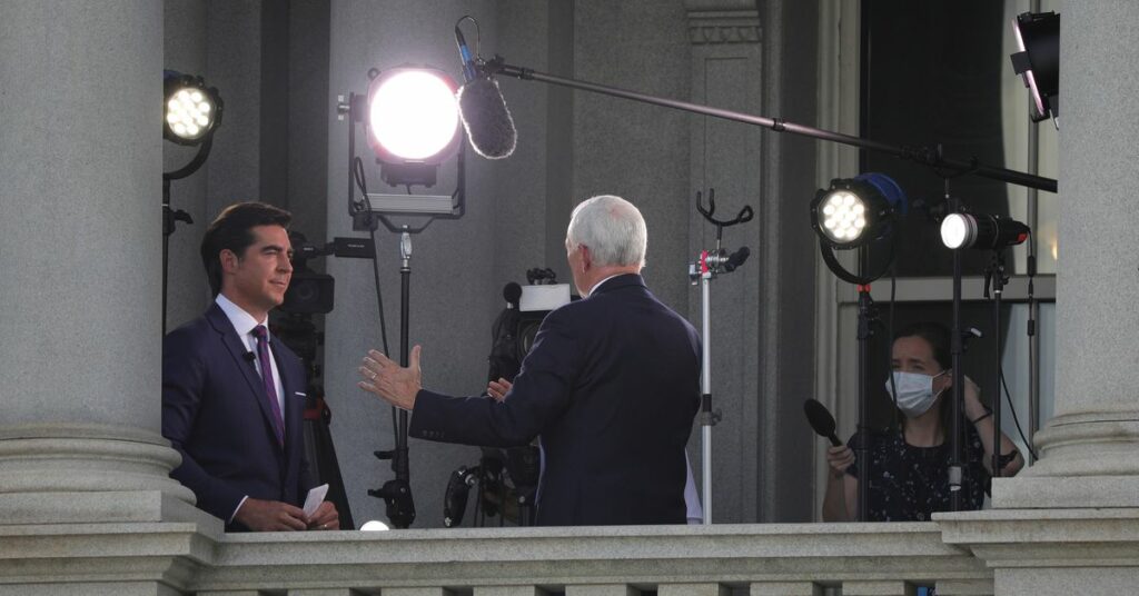 Fox News commentator Jesse Watters speaks to U.S. Vice President Mike Pence during a television interview in the Eisenhower Executive Office Building at the White House in Washington