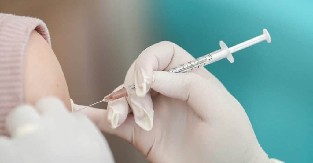 A woman receives a booster dose of Pfizer-BioNTech vaccine against the coronavirus disease (COVID-19) at the Police hospital in Bangkok