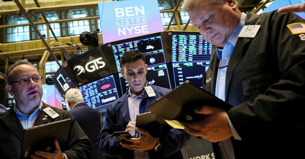 Traders work on the floor of the NYSE in New York