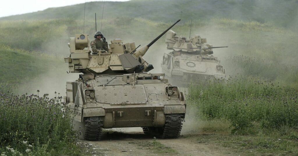 U.S. servicemen drive Bradley infantry fighting vehicles during the joint U.S.-Georgian exercise Noble Partner 2015 at the Vaziani training area outside Tbilisi