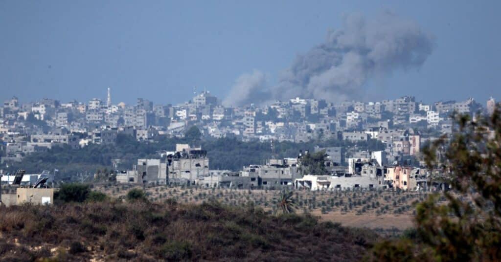 A view shows smoke in the sky and destroyed buildings in the Gaza Strip as seen from Israel's border with the Gaza Strip, in southern Israel